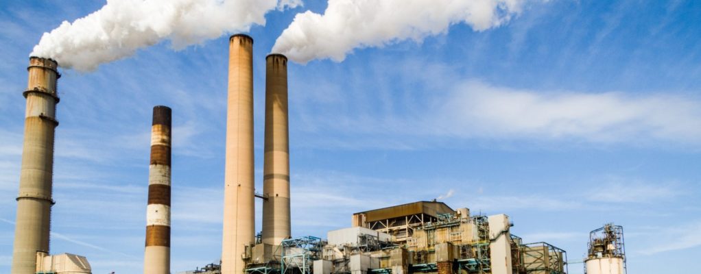 Power plant with smoke coming out of pillars