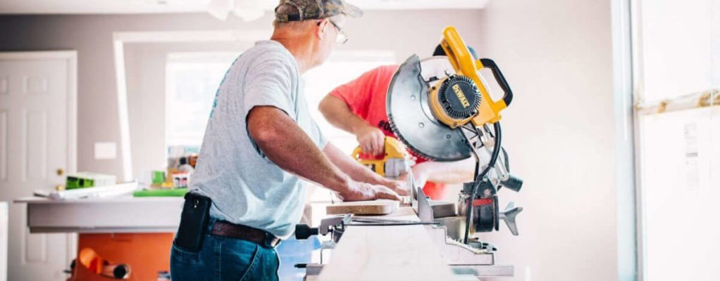 Man cutting wood with a saw