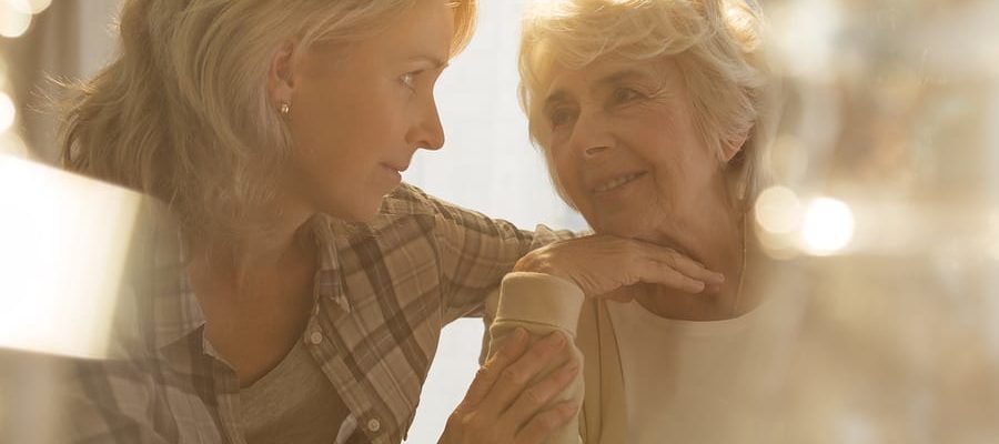 Older woman being comforted by younger woman