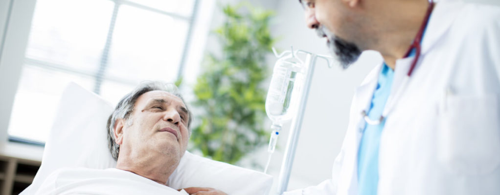 an older male cancer patient with a doctor