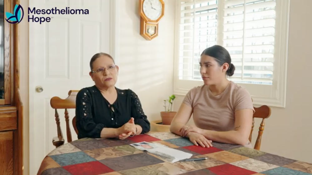Two members of Oscar Avila's family sit at their dining room table