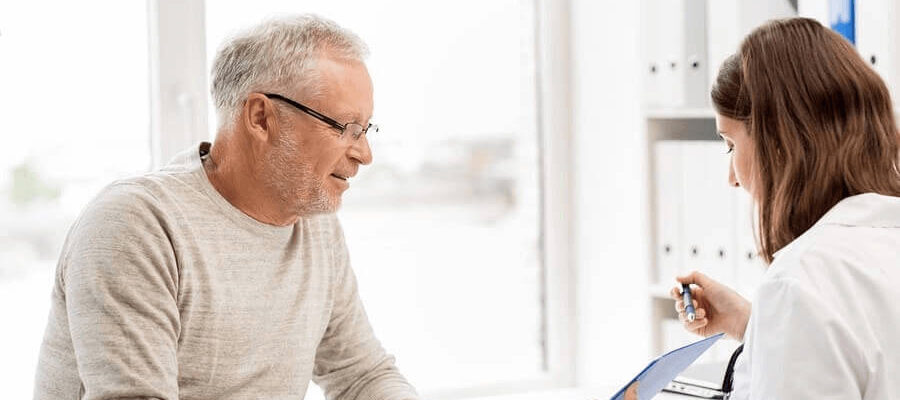 Man sitting with woman doctor