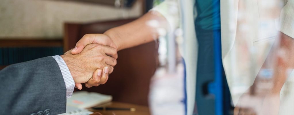 A man and woman shaking hands