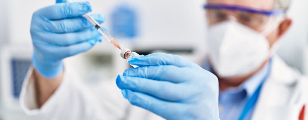Scientist using a syringe in a laboratory