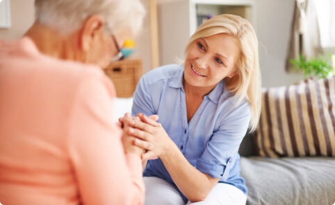 Woman providing support to an elderly patient