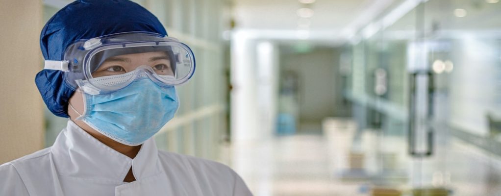 a health care worker with a face mask and goggles