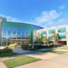 Moores Cancer Center view from outside. Two large buildings are seen next to each other on a sunny day.